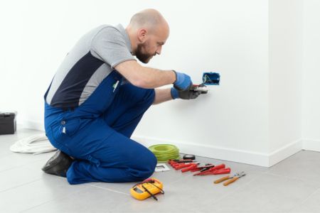 Certified electrician replacing a GFCI outlet.