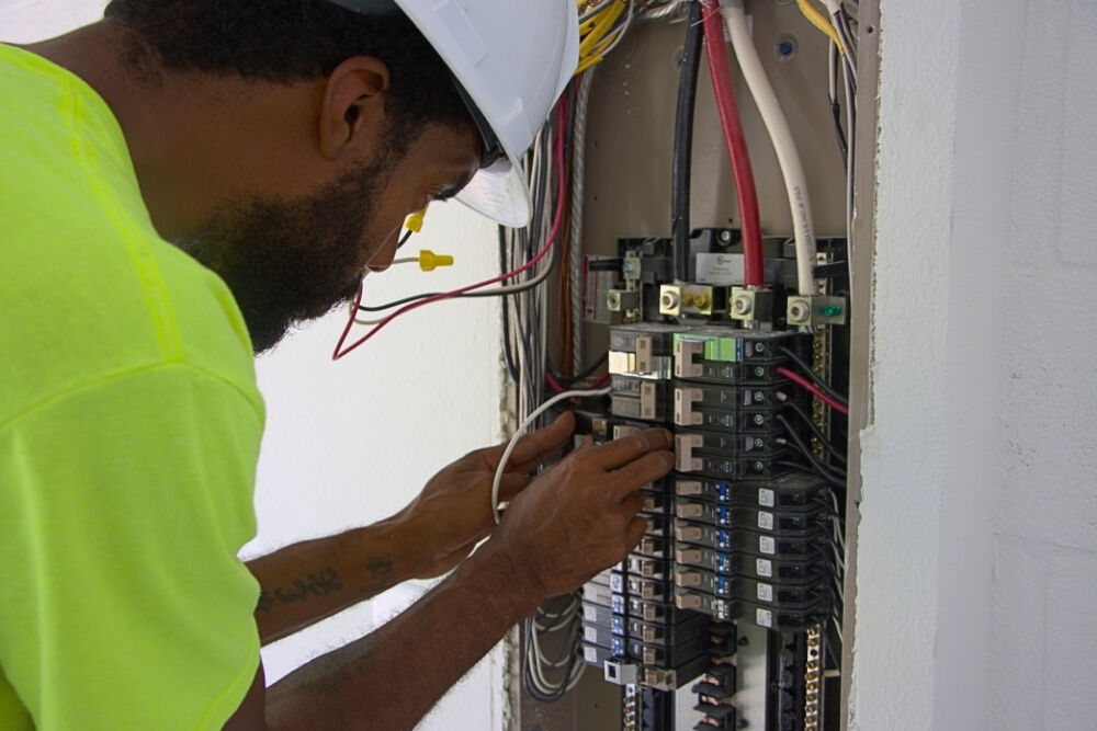 Electrician diagnosing electrical panel problems at a customer's home